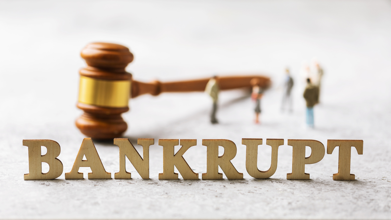 Lettering from wooden letters, judge gavel and men, bankruptcy