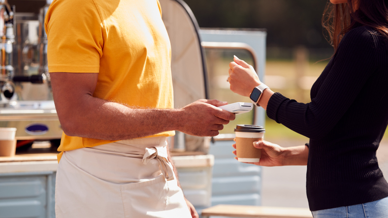 Customer Making Contactless Payment Using Smart Watch At Mobile Coffee Van