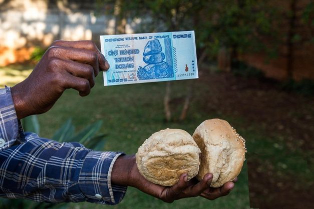 a one hundred trillion dollar note being swapped for two coconuts